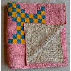 This is a wonderful early 20th-century meticulously hand-stitched summer-weight New England quilt in brightly colored yellow and blue squares on a red calico ground, and it also has a small geometric pattern on the back. The quilt pattern is a Triple Irish Chain. It has a great feel and can be used on a bed, displayed on a wall, or draped over furniture. It's nice on both sides.  Deirdre’s Bio: This comes from the archives of Deirdre Coughlin, founder of Phoebe’s Closet. She specializes in antiq Quilt Squares Patterns, Yellow Brick Road Quilt, Triple Irish Chain, Quilt Tapestry, Scandinavian Quilts, Small Geometric Pattern, Quilt Board, Hand Stitched Quilt, Irish Chain Quilt