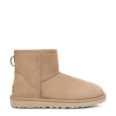 These women's UGG Classic Mini II sand boot is designed to keep you warm and on-trend, without the heavy weight. Made with soft sheepskin upper, these cold weather booties have a round toe front, easy slip-on design, Post-Applied Treatment Treated to repel light amounts of water, rear pull tabe, soft sheepskin lining, polyester binding, suede heel counter with embossed UGG® logo heel label, and a durable Treadlite by UGG™ lightweight outsole. | Ugg Women's Classic Mini II Boot in Sand Suede Size 5 Medium Classic Mini Ii Boot, Denim Stars, Sand Boots, Ugg Classic Mini Ii, Ugg Classic Mini, Wide Width Shoes, Ugg Classic, Trail Shoes, Retro Sneakers