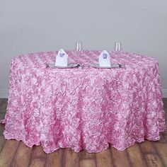 the table cloth is pink with white flowers on it