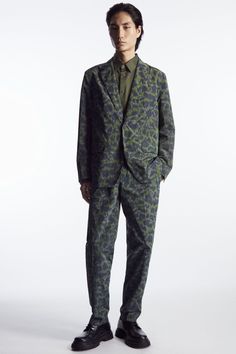 Classic and contemporary tailoring codes come together in this blazer from the Autumn Winter menswear collection. Expertly tailored on our regular-fit block, it's crafted from recycled fabric that's jacquard-woven with a refined take on animal print and has an angled chest welt pocket, flapped front pockets and a back vent to prevent creasing as you sit. Embrace a maximalist sensibility by styling it with the coordinating trousers. Regular fitMother-of-pearl buttonsA better alternative to conventional polyester, recycled polyester is made from pre‐ and post‐consumer waste Shell & Lining: 100% Recycled polyester / Machine wash Back length of size EU 48 is 73.25cm / Model wears a size EU 48 Custom Blazer, Winter Menswear, Menswear Collection, Winter 2023, Jacquard Weave, Mother Of Pearl Buttons, Color Khaki, Recycled Fabric, Welt Pocket