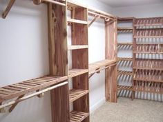 an empty walk in closet with wooden shelves