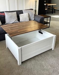 a coffee table with storage underneath it in a living room area next to a couch