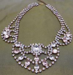 Dazzling vintage statement costume festoon necklace with pink paste fx gems and endless diamantes. Timeless elegant design with show-stopping sparkle.  1940s/50s glamour piece ... as beautiful today as it was ... and will be for many moons to come Excellent vintage condition Length: Adjustable 41.5 - 46 cm / 16.2 - 18 inch Drop: 5.7 cm / 2.2 inch ☞ Please view my shipping and sales policies & ✎ Contact me with questions prior to purchase...all sales are final:  http://www.etsy.com/shop/Andeebird/policy Glamorous Pink Evening Necklaces, Elegant Pink Rhinestone Formal Necklace, Elegant Pink Rhinestone Necklace With Jewels, Elegant Pink Rhinestone Necklace For Party, Glamorous Pink Rhinestone Necklace, Elegant Pink Rhinestone Party Necklace, Elegant Pink Rhinestone Necklace With Sparkling Stones, Pink Crystal Rhinestone Necklace In Glamorous Style, Pink Costume Jewelry Necklace For Evening