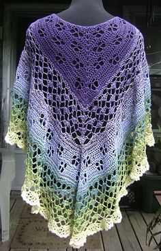 a purple and green crocheted shawl on a mannequin