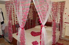 a bed with pink and white decorations on it