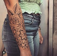 a woman with a rose tattoo on her arm