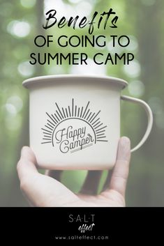 a hand holding a cup with the words benefits of going to summer camp