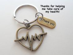 "This listing is for a keychain with a heartbeat charm and thank you charm. These are great gifts for doctors, nurses or other medical professionals and educators. The heart charm is a little more than 1 inch in size. The keychain will come on a card that says \"Thanks for helping me take care of my health\". See my other medical related items here: https://www.etsy.com/shop/JewelryEveryday?ref=seller-platform-mcnav&search_query=medical Check out my other employee appreciation keychain listi Doctor Gifts Thank You, Gifts For Doctors And Nurses Thank You, Medical Jewelry Doctors, Nurse Keychain, Medical Keychain, Steel Anniversary Gifts, Wood Anniversary Gift, Leather Anniversary Gift, Copper Anniversary Gifts