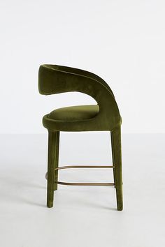 a green chair sitting on top of a white floor