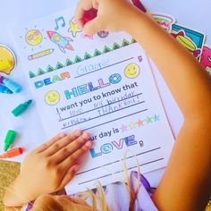 a child's hand on top of a paper