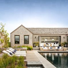 an outdoor living area next to a swimming pool