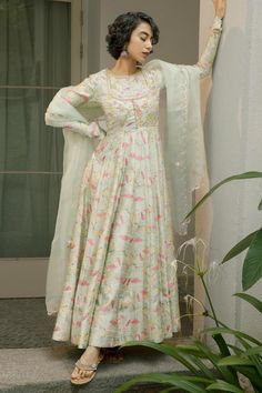 Mint green flared blossom anarkali with an embroidered body yoke. Paired with a silk organza dupatta with scalloped edges.
Components: 2
Pattern: Print, Embroidery
Type Of Work: Floral, Birds
Neckline: Round Neck
Sleeve Type: Full Churidar Sleeves
Fabric: Anarkali: Printed Tussar, Dupion Silk
Dupatta : Silk Organza 
Color: Green
Other Details: 
Attached lining
Model height: 5 ft 7 inches, wearing size S
Length from shoulder(in inches): 58
Closure: Side zipper
Note:
Anarkali does not come with pa Churidar Sleeves, Floral Anarkali, Green Anarkali, Print Embroidery, Dupion Silk, Organza Dupatta, Silk Dupatta, Silk Organza, Scalloped Edges