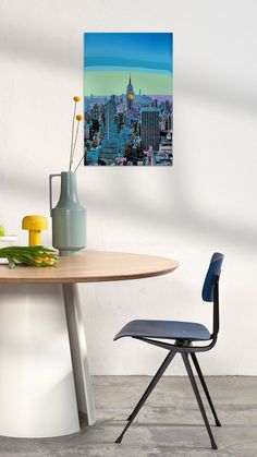 a table and chair in front of a wall with a large clock tower on it