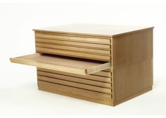 a wooden desk with two drawers on the top and one drawer open to show it's contents