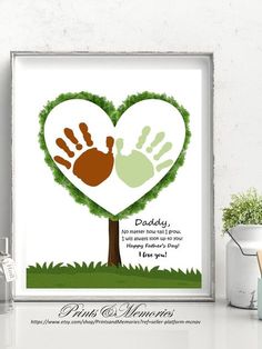 a heart shaped tree with two hands and the words daddy written on it in green