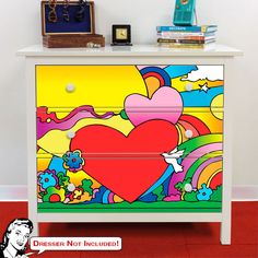 a colorful chest of drawers with a heart painted on it