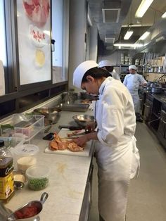 a woman is preparing food in a kitchen