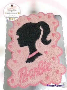 a cake that is shaped like a woman's silhouette with pink and black icing