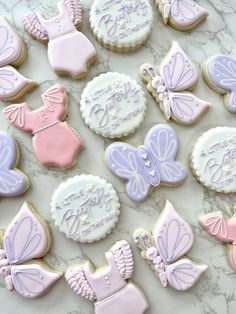 many decorated cookies are displayed on a table