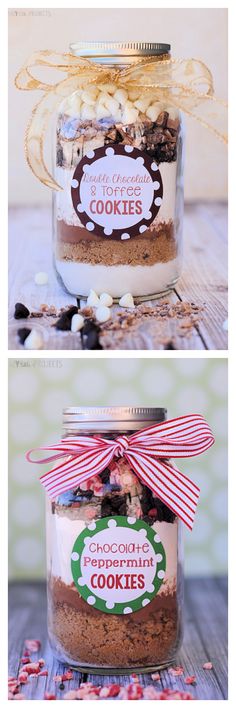 two jars filled with cookies on top of a wooden table