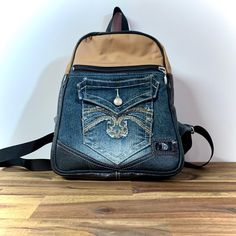 Get noticed with your small backpack with multiple exterior and interior pockets. Size: 11 x 9 x 3 inches. Made of jeans and leather. Unique model, only 1 of each. Have a unique look with your backpack made of upcycled jeans and leather. Lots of pockets inside and outside. size: 11 x 9 x 3 inches. Very unique model only one available. Backpack Purses, Upcycled Jeans, Denim Backpack, Upcycle Jeans, Lots Of Pockets, Small Backpack, Refashion Clothes, Backpack Purse, Only 1