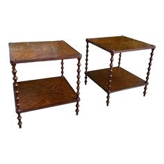 two wooden side tables with turned legs on each end, one is holding a shelf