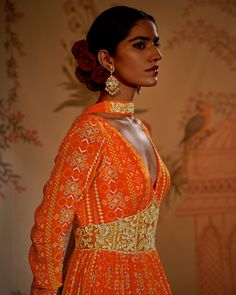 Editor's Note The tangerine patola anarkali and dupatta is a captivating ensemble that exudes traditional charm with a modern twist. The vibrant tangerine hue of the anarkali is enhanced by the intricate patola weave, showcasing a beautiful blend of colors and patterns. Paired with a matching dupatta, this ensemble is perfect for festive occasions and celebrations. Color: Orange Fabric: Anarkali: crepe silk, dupatta: georgette crepe Components: Anarkali and dupatta Occasion: Festive Disclaimer: Orange Anarkali, Churidar Sleeves, Patola Print, Anarkali With Dupatta, Embroidered Corset, Blouse Yoke, Corset Belt, Indian Fashion Designers, Orange Fabric