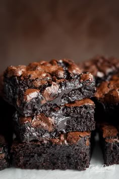 chocolate brownies stacked on top of each other with one bite taken out of it