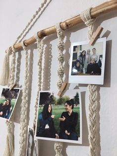 some pictures hanging on a wall with rope