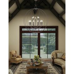 a living room with couches, chairs and a chandelier in the center