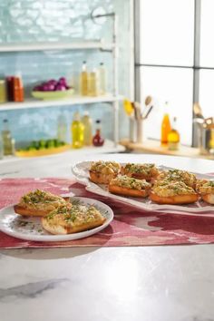 two plates with food on them sitting on a counter