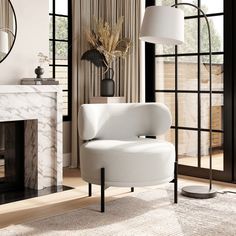 a white chair sitting next to a fireplace in a living room