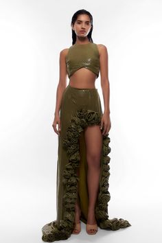 Olive green crop top with all-over tonal sequin embellishment and curved hem. Comes with 3D flower embellished co-ordinating skirt.
Components: 2
Pattern: Embellishment
Type Of Work: Sequin
Neckline: Closed Neck
Sleeve Type: Sleeveless
Fabric: Georgette and Chiffon
Color: Green
Other Details: 
Skirt with side slit and 3D flower detailing
Keyhole cutout at the back
Occasion: Party - Aza Fashions Sequin Top With Skirt, Top With Skirt, Embellished Crop Top, Embellished Skirt, Sequin Embellishment, High Neck Designs, Sequin Crop Top, High Neck Top, Green Sequins