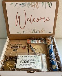 an open welcome box with various items inside