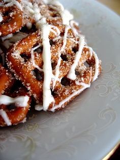 a white plate topped with donuts covered in icing