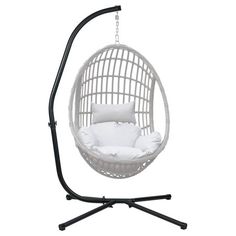 a white hanging chair with pillows on it and a black stand for the swing seat