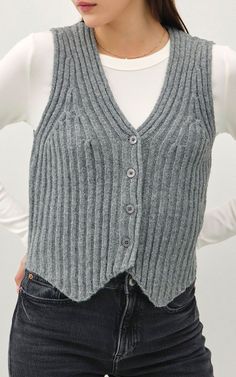 Upgrade your wardrobe with this versatile and stylish Ribbed Knit Button Down Sweater Vest. Instantly elevate any outfit with the added texture and detailing of the ribbed knit and button down design. Perfect for layering and adding a touch of sophistication to your look.BRAND: BE COOLDETAILS: Vneck Button Down Front Closure Irregular Hemline Relaxed Fit FABRIC: 100% POLYESTERMEASUREMENTS: Size S/M - Bust: 34" Length: 18"LIVE FIT DESCRIPTION: Be sure to watch the full FIT VID in the App (SHOP BAD HABIT) to see how it looks and fits on our Live Team! SIZE GUIDEBHB BABES SIZING INFO: The Owner, SARA (long blond hair), is wearing a size SMALL and would stick with her size.  She is 5'7" with a 36C bust and an Athletic body typeShe normally wears a size Small in Tops and Bottoms Her store denim Button Down Sweater Vest, Long Blond, Button Down Sweater, Athletic Body, Live Fit, Bad Habit, Be Cool, High Rise Denim, Denim Flares