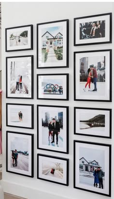 a group of people standing in front of a wall with pictures on it