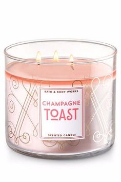 a pink candle that is inside of a glass container with the words champagne toast on it