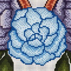 a cross stitch pattern with an image of a blue flower