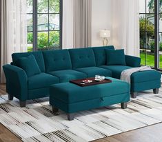 a living room with a blue couch and ottoman