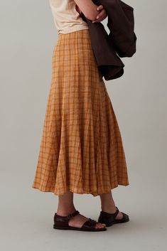 The Diya Skirt is a paneled and subtly pleated skirt that hits above the ankle. In lightweight and breezy gauze plaid, Diya sits on the natural waist, is fitted through the waist and hips and is balanced with a flouncy skirt. Features a side zip for ease. Fall Maxi Skirt Outfits, Maxi Skirt Fall, Flouncy Skirt, Modest Mouse, Maxi Skirt Outfits, Knit Outerwear, Paneled Skirt, Summer Stripes, Fall Skirts