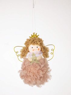 an angel ornament hanging from a string with a gold crown on it's head