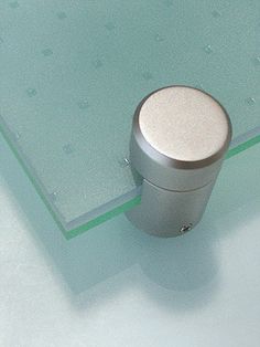 a close up of a glass table with a metal object on it's surface