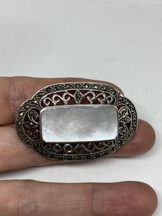 Vintage Pin Marcasite 925 Sterling Silver Brooch Vintage brooch All 925 sterling silver Genuine Marcasite and mother of pearl About 2 inch All jewelry is shipped free in the US in a nice gift box. Check out our over a THOUSAND great reviews Engraving is $4 per letter and is not always perfect depending on the piece. It can take a few days if the jeweler is busy. This is payable to Paypal Judithsltd@gmail.com White Oval Brooches For Gifts, White Oval Brooch For Anniversary, Antique White Brooches As Gift, White Antique Brooches As A Gift, Victorian White Brooch For Anniversary, White Hallmarked Brooches As Gift, White Sterling Silver Brooches As Gift, Ornate White Brooches As Gift, Elegant Silver Brooches Stamped 925