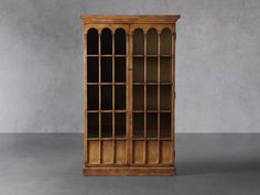 an old wooden bookcase with glass doors on the front and bottom, against a gray background