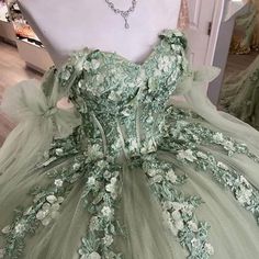 a green dress with flowers on it