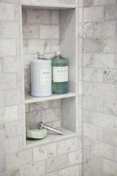 an image of a bathroom with white tile and grey grouting on the walls