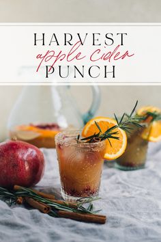 an apple cider punch with orange slices and rosemary garnish