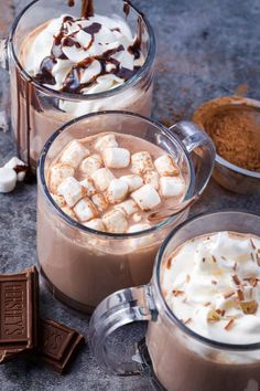 two glasses filled with hot chocolate and marshmallows